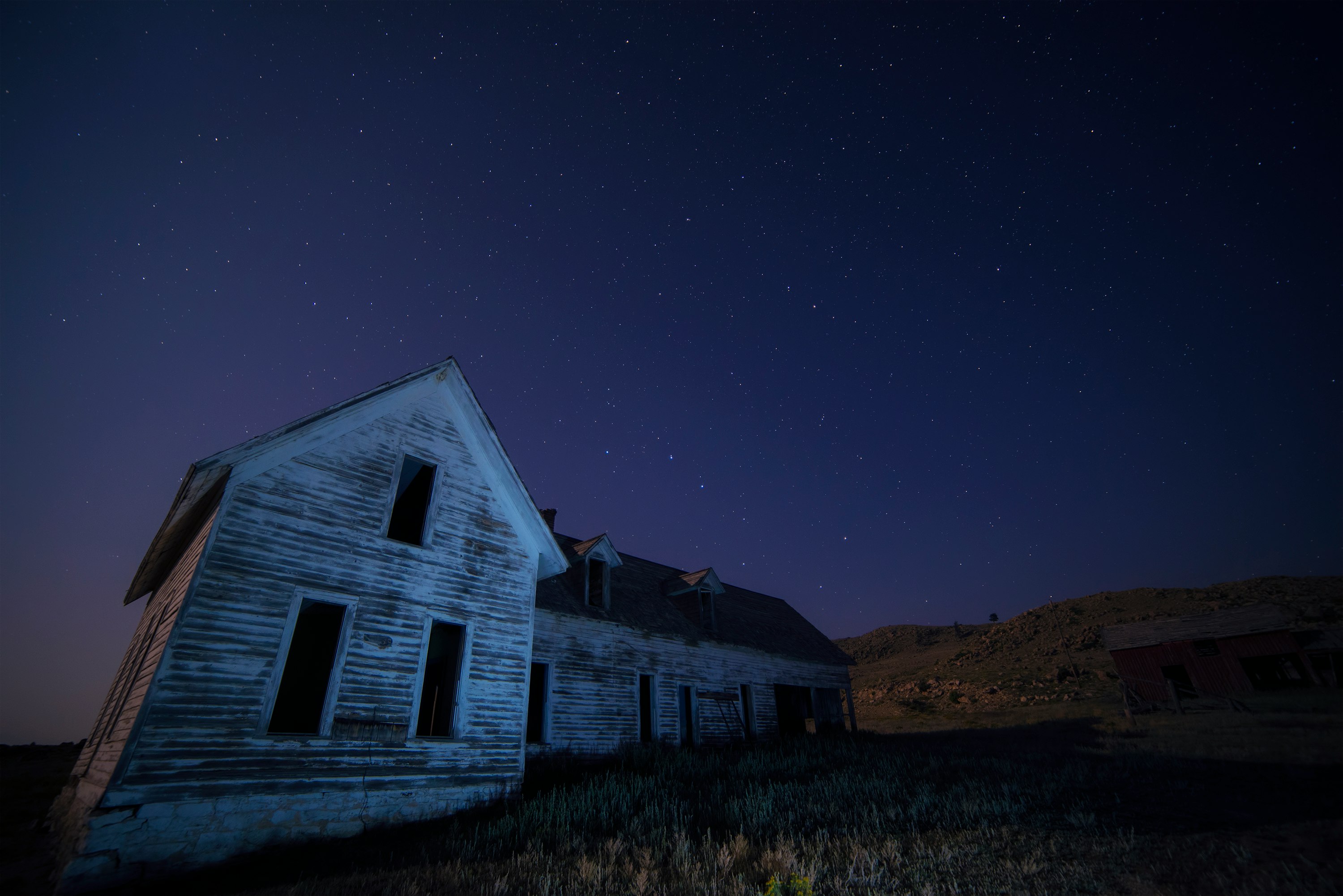 house on field under sky with stars